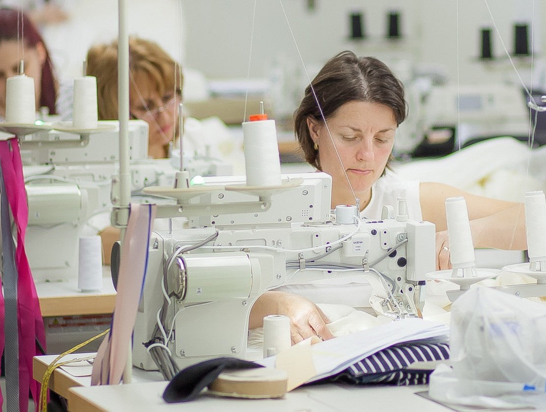 Fair Fashion Saywood Ethical Manufacturer Mantra, machinists sewing the garments on the production line.