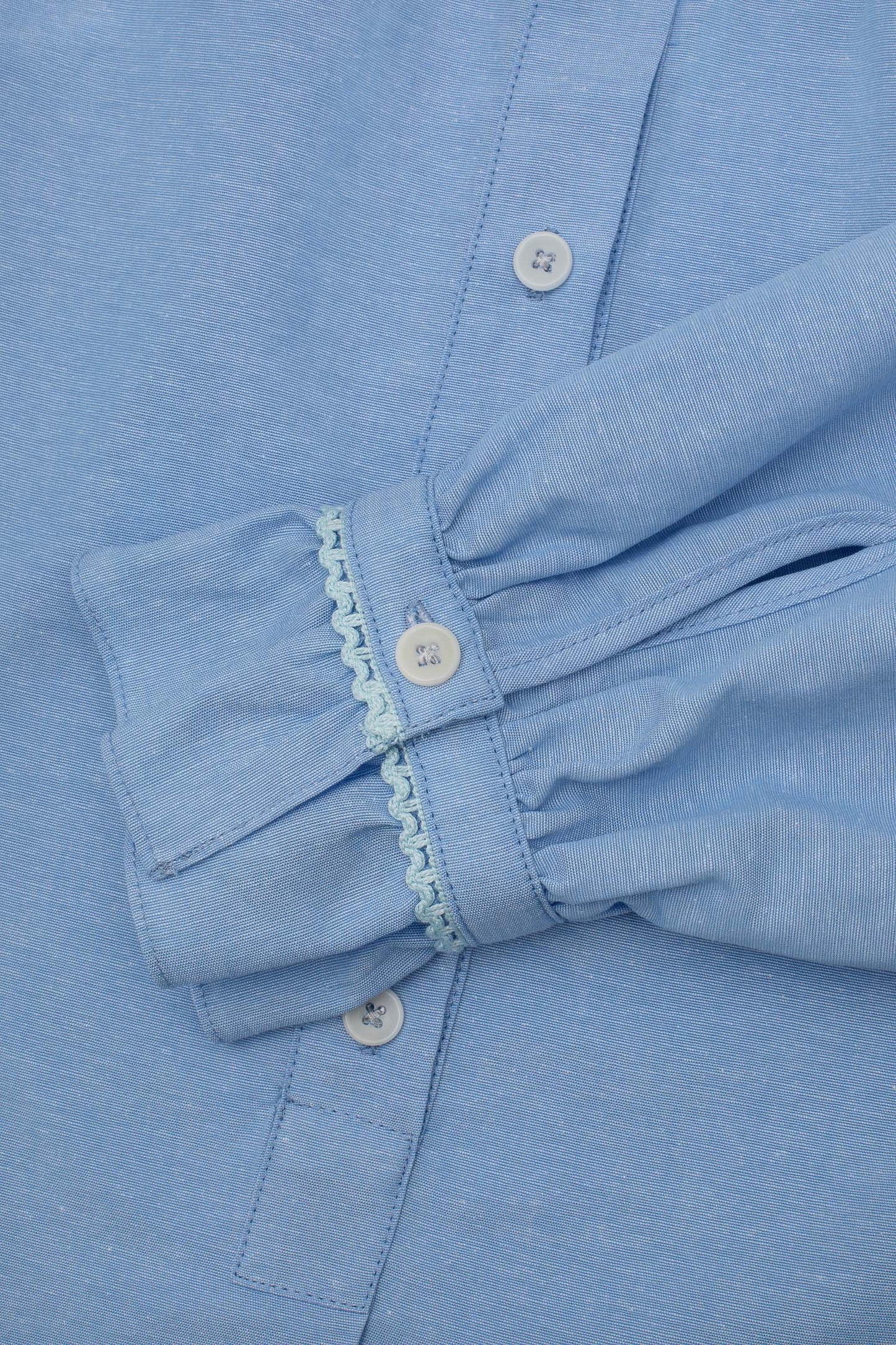 Womens Pale Blue Blouse, A-line shape with Gathered Neck and Frill cuffs. Marie Blouse by Saywood in pale blue recycled cotton. Close up of gathered cuff with lace trim.