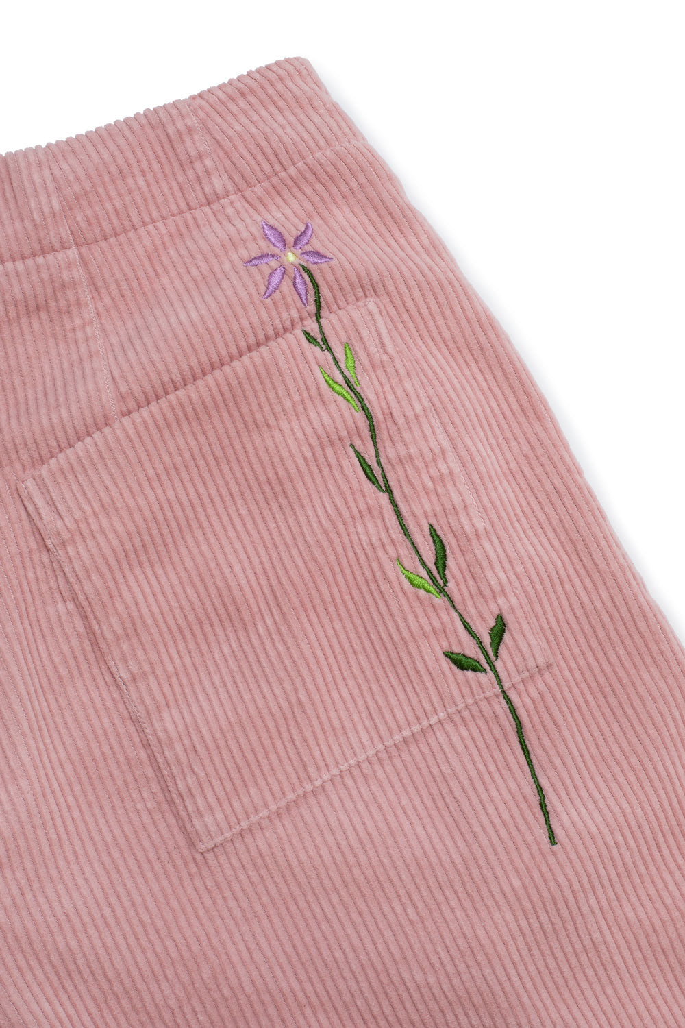 Close up flat shot of the back patch pockets of the Amelia Wide Leg Culotte Trousers by Saywood. The signature embroidered flowers in lilac can be seen stitched through the back pocket.