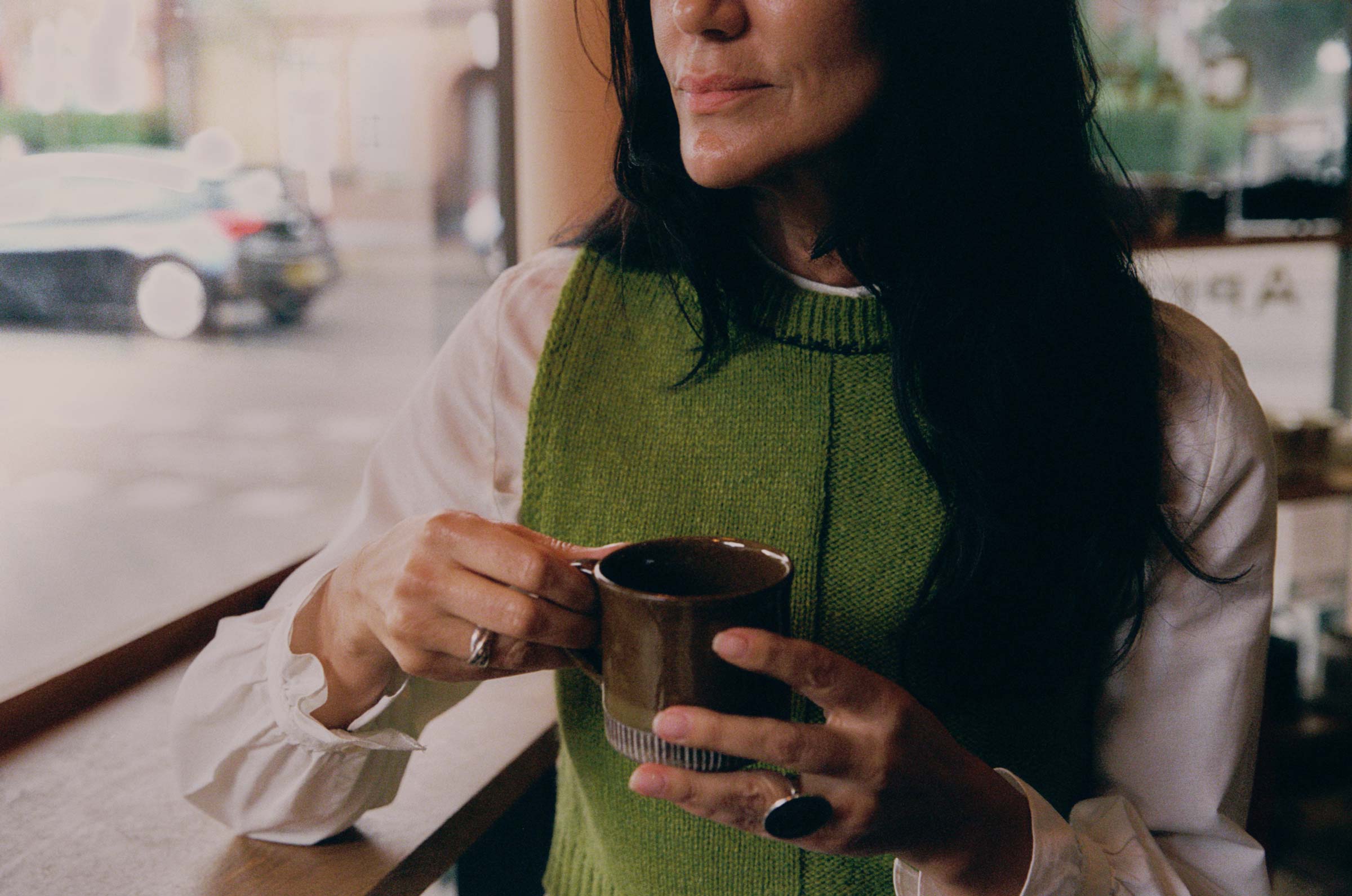 Ada Sweater Vest in moss green lambswool, layered over a white shirt — sustainable British knitwear made in London by Saywood
