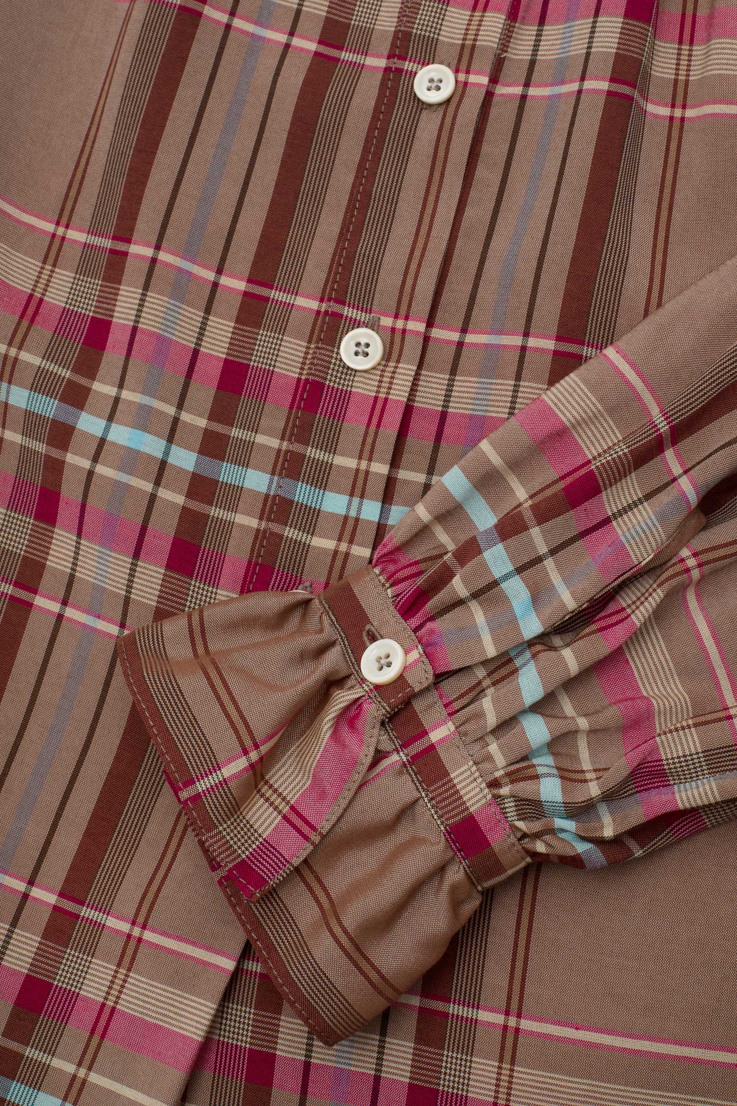Women's pink and hazelnut check shirt, close up of the gathered frill cuff and button placket. Saywood's Marie A-line Gathered Neck Blouse, made in London, UK.