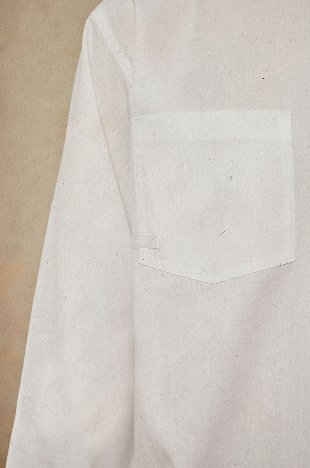 Close up of Saywood's Eddy Mens white Shirt showing the patch pocket with cotton herringbone tape on the bottom corner of the pocket.