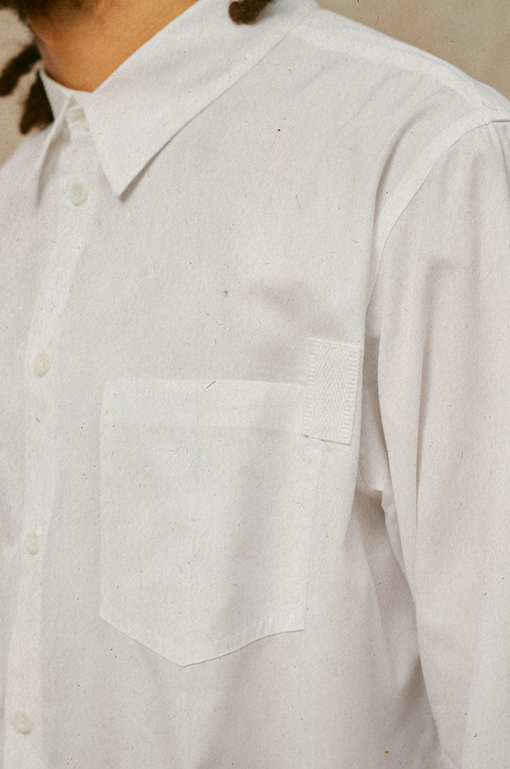 Close up of Saywood's Eddy Mens white Shirt showing the patch pockets with cotton herringbone tape on one corner.
