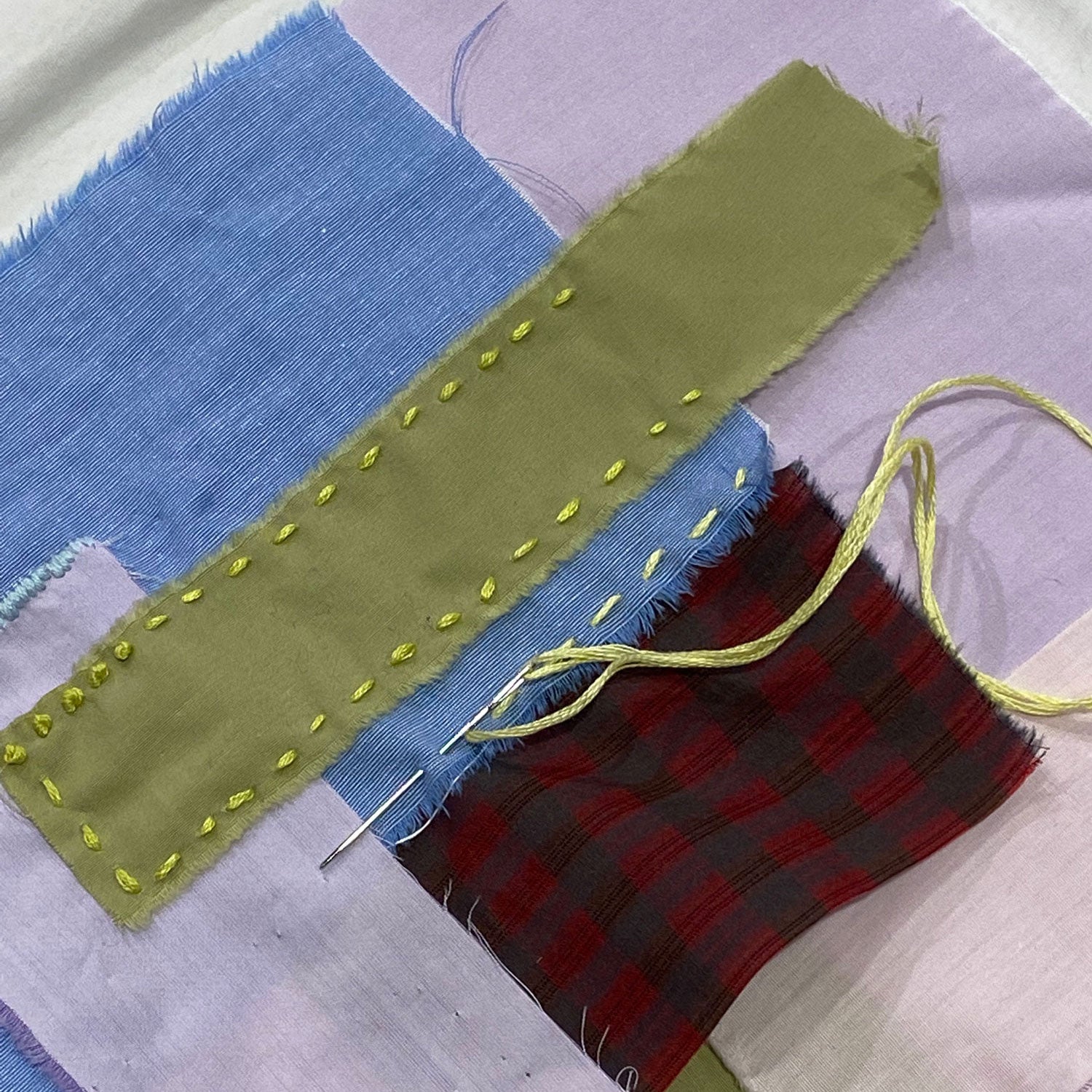 Colourful fabric swatches with hand sewing and darning stitch samples