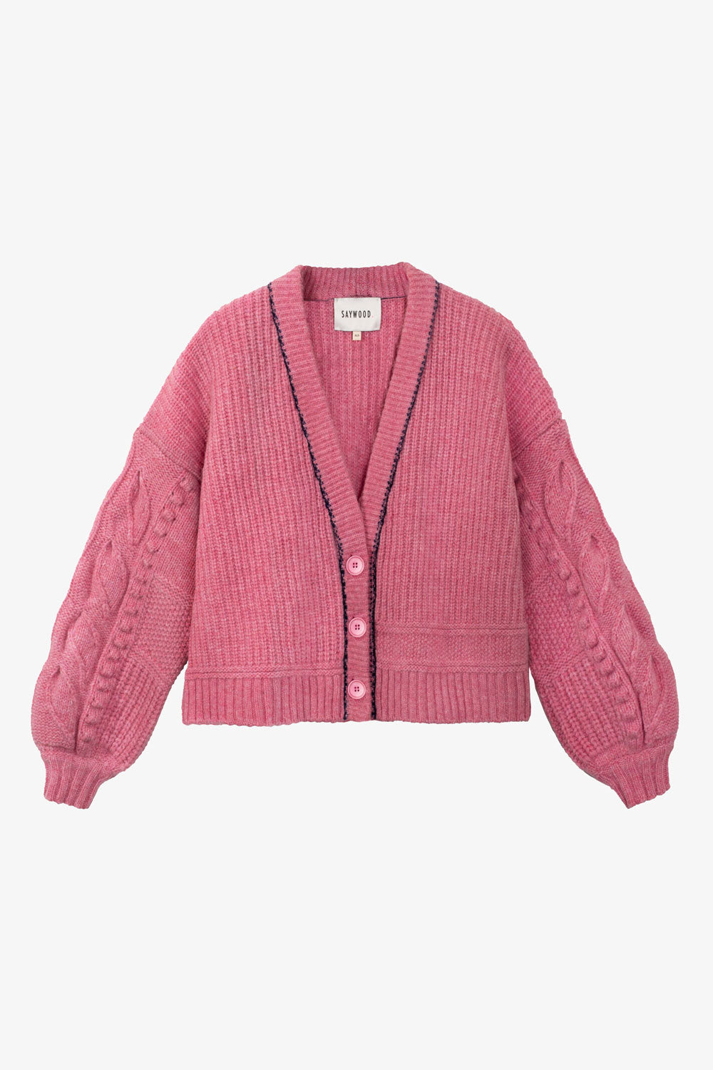 Pink chunky knit cardigan with navy stitching trim around the neck on a light grey background. Made in the UK.
