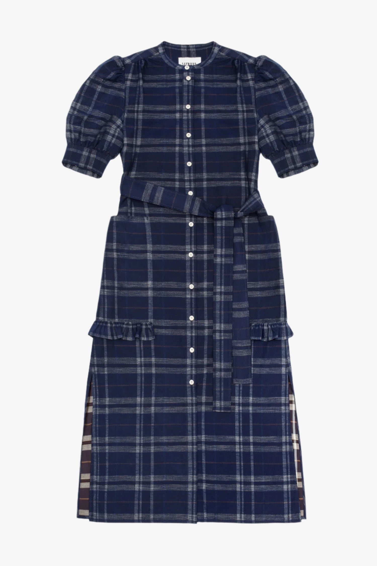 Women's navy check puff sleeve dress, long line with side splits at the hem. The Rosa Dress by Saywood has patch pockets at the hip with ruffles at the bottom of the pockets, with a tied matching belt around the waist. Dress is on a white background.