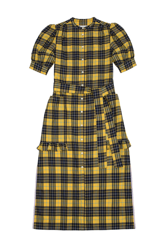 Womens yellow and navy check puff sleeve dress, long line with side splits at the hem. The Rosa Dress by Saywood has patch pockets at the hip with ruffles at the bottom of the pockets, with a tied matching belt around the waist. Dress is on a white background.