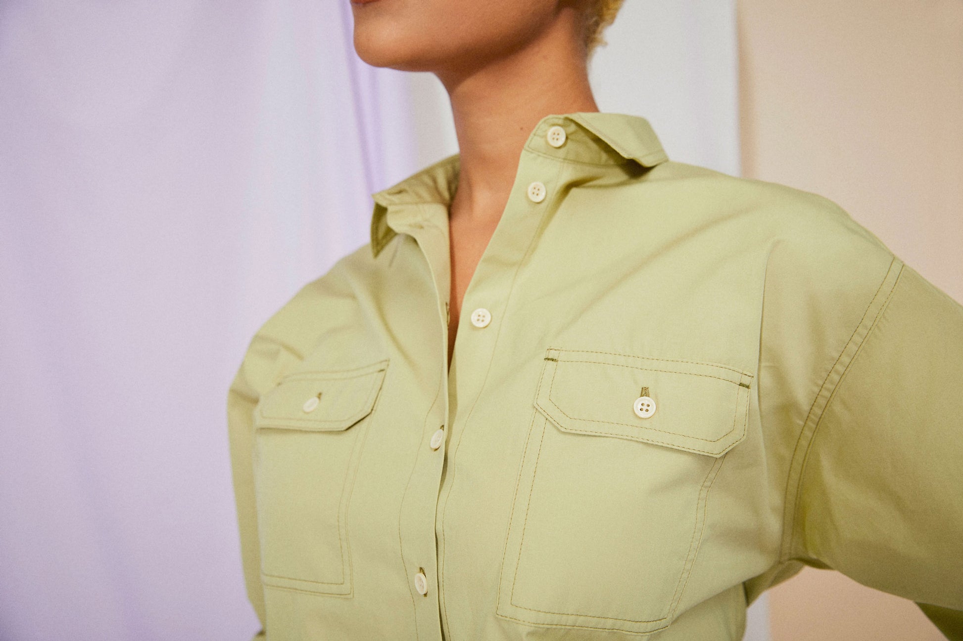Womens Oversized Shirt in khaki olive, with detachable tie belt and safari styling details. Belted cuffs for sleeve details and utility patch pockets. Zadie Boyfriend Shirt by Saywood. Close up of utility patch pockets.