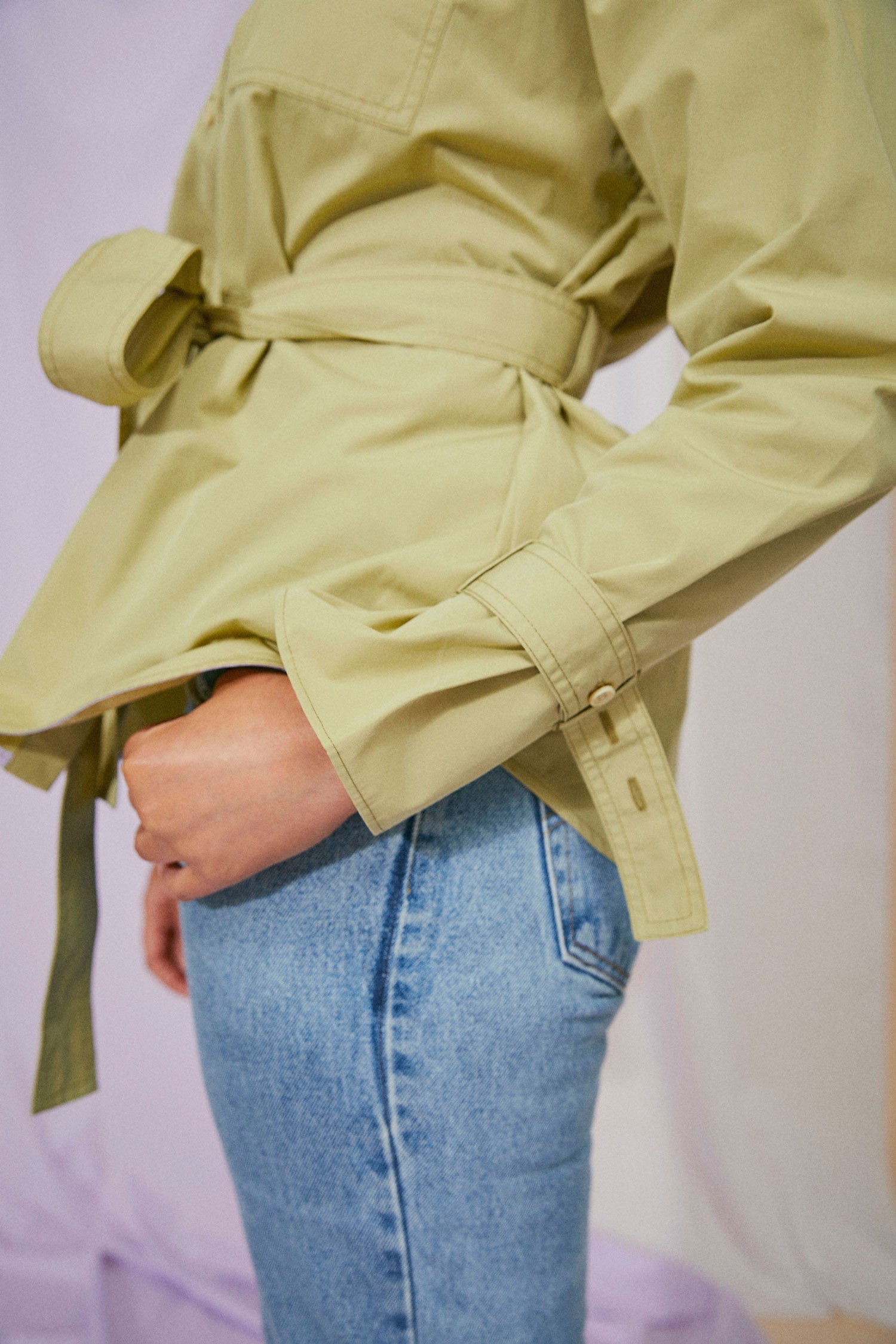 Womens Oversized Shirt in khaki olive, with detachable tie belt and safari styling details. Belted cuffs for sleeve details and utility patch pockets. Zadie Boyfriend Shirt by Saywood. Close up of sleeves and tie belt details.