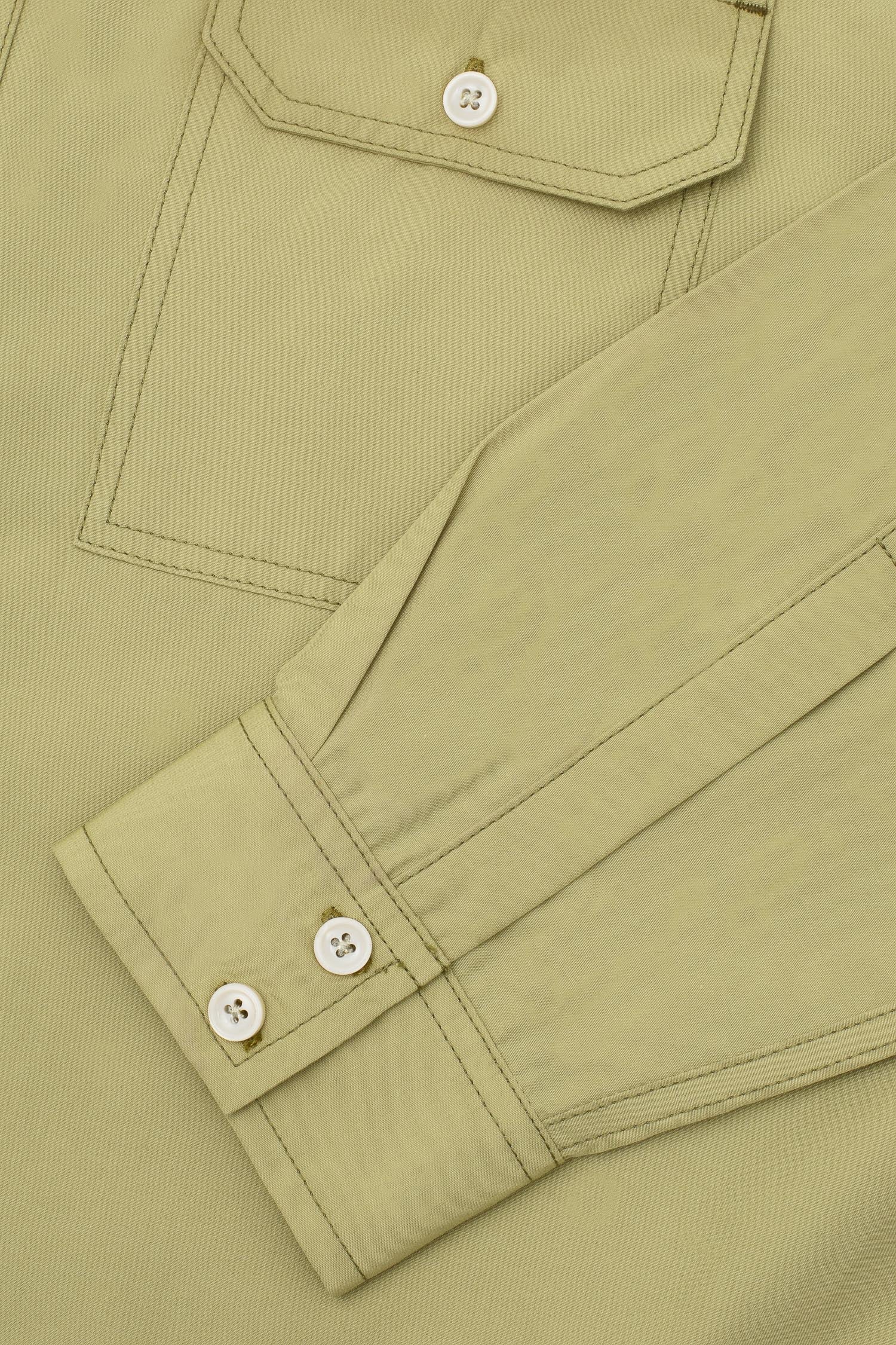 Mens Utility Shirt in olive khaki cotton. Close up of the utility Patch Pocket details and double button cuff; the Eddy Shirt regular fit by Saywood.