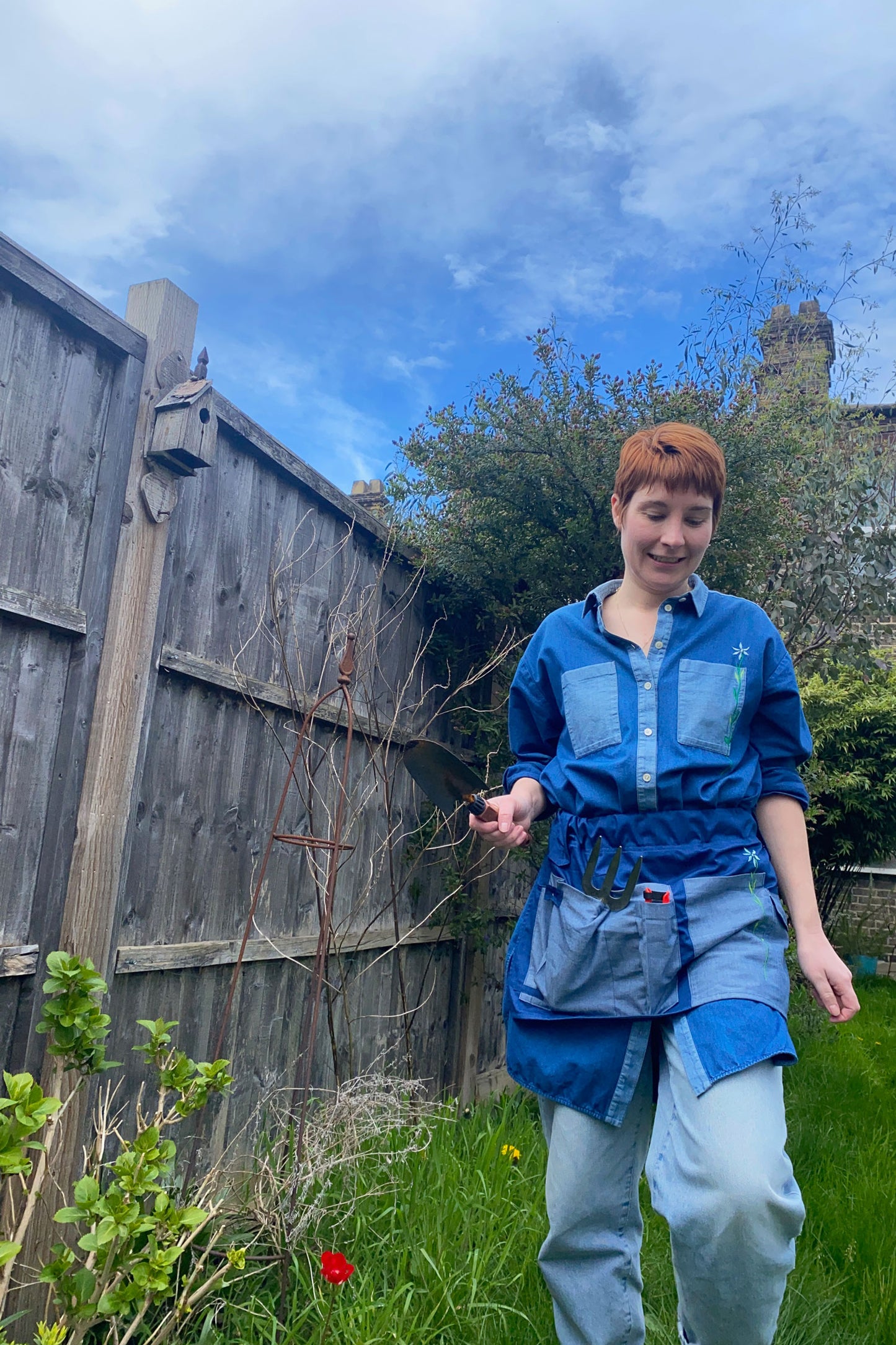 Tool Belt made in Japanese Denim, for the garden or multifunctional, by Saywood. Woman wears the tool belt in the garden