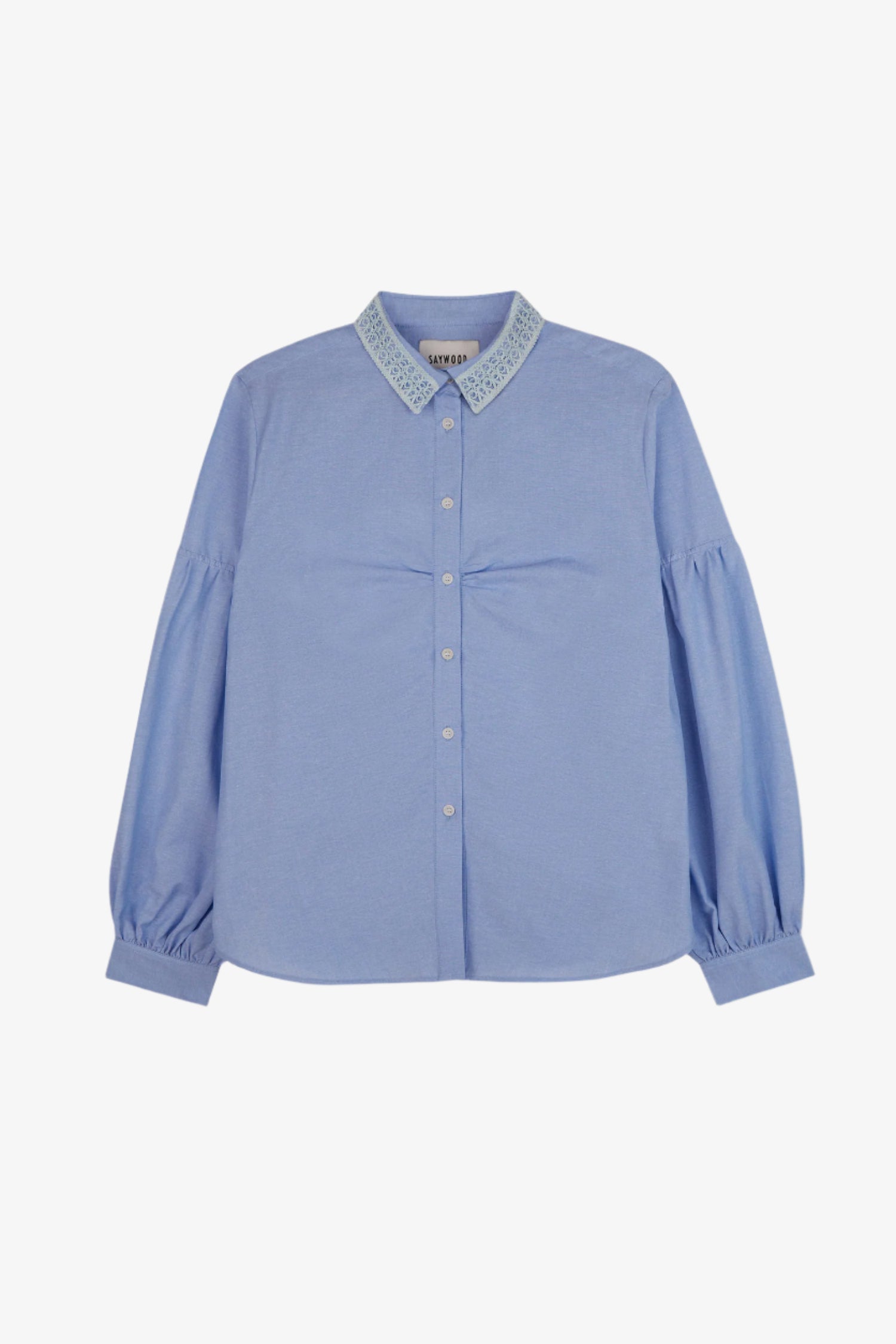 Womens pale blue shirt with lace trim collar and volume sleeves. Soft gathering is at the bust, with shirt made in recycled cotton. Shirt is on a white background