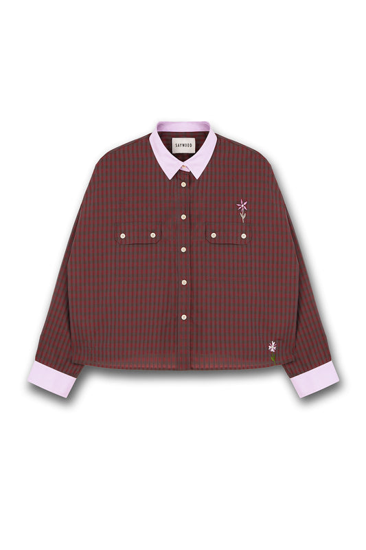 Womens mini red check shirt with a boxy silhouette. Jules Shirt from Saywood with embroidered flower detail, utility style pockets, and lilac contrasting collar and cuffs.
