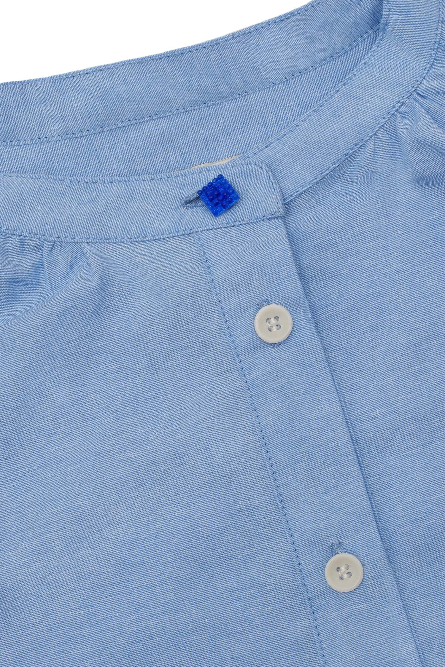 Womens Pale Blue Blouse, A-line shape with Gathered Neck and Frill cuffs. Marie Blouse by Saywood in pale blue recycled cotton. Close up of neckline, grandad collar with vintage glass button at neck of the limited edition version.