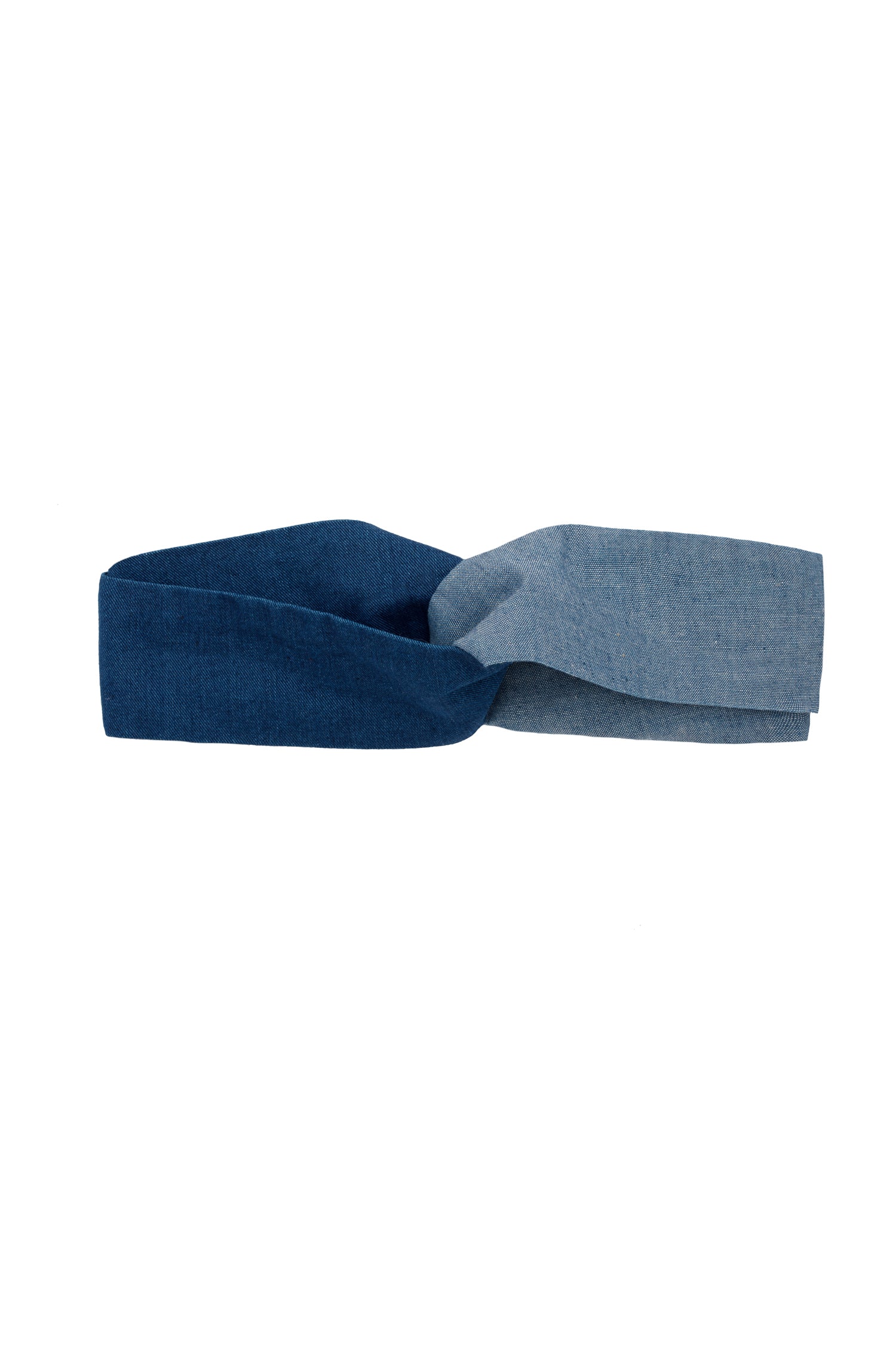 Saywood's Thandi Headband with twist effect, made from contrasting mid wash and light wash natural indigo Japanese denim. Laid flat with only the top of the headband visible.